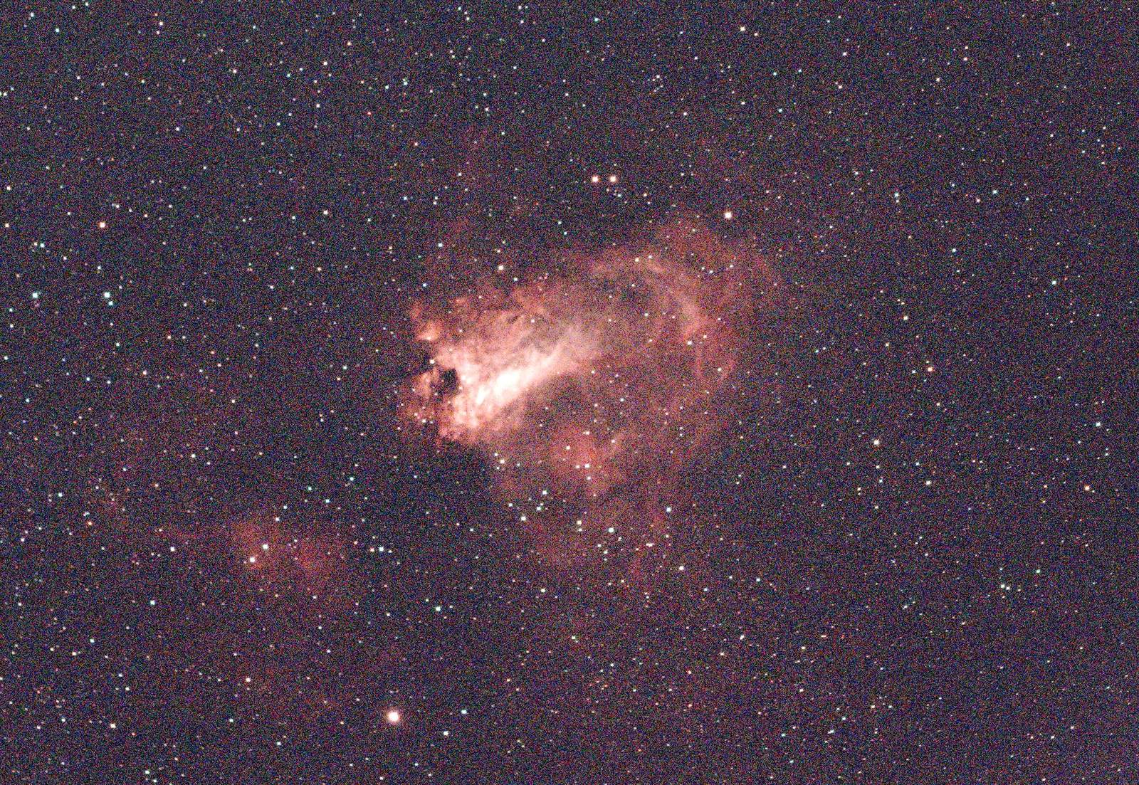 One 30-second frame of the same field, stretched to be visible: grainy, with the nebula faint against a noisy purple sky.