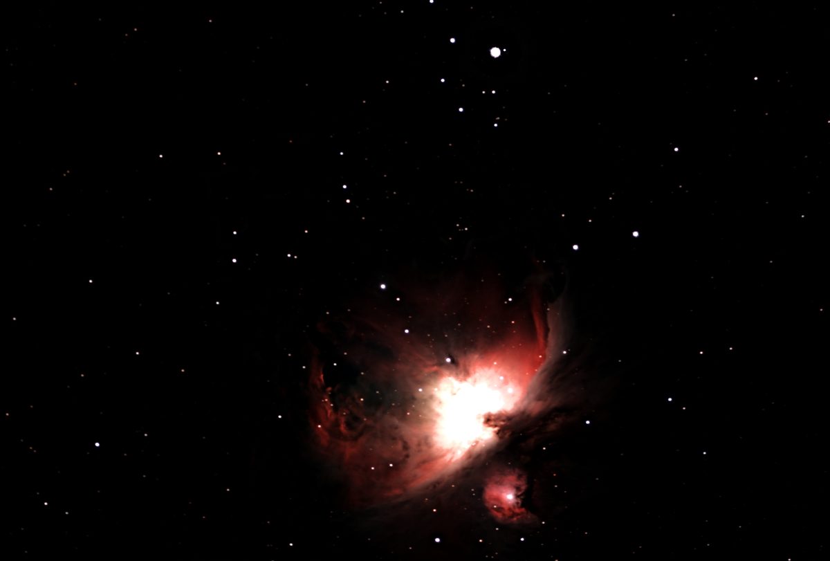 The Orion Nebula with its bright central cloud and surrounding gas.